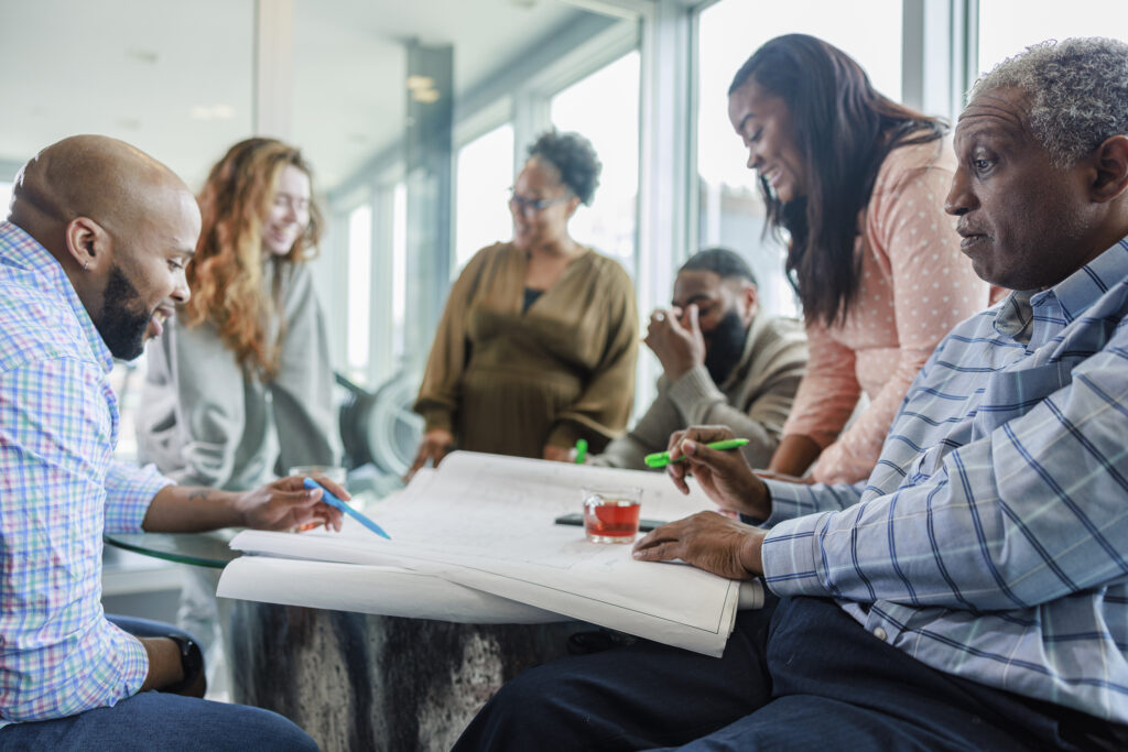 Discussion among coworkers from different races about a working project.